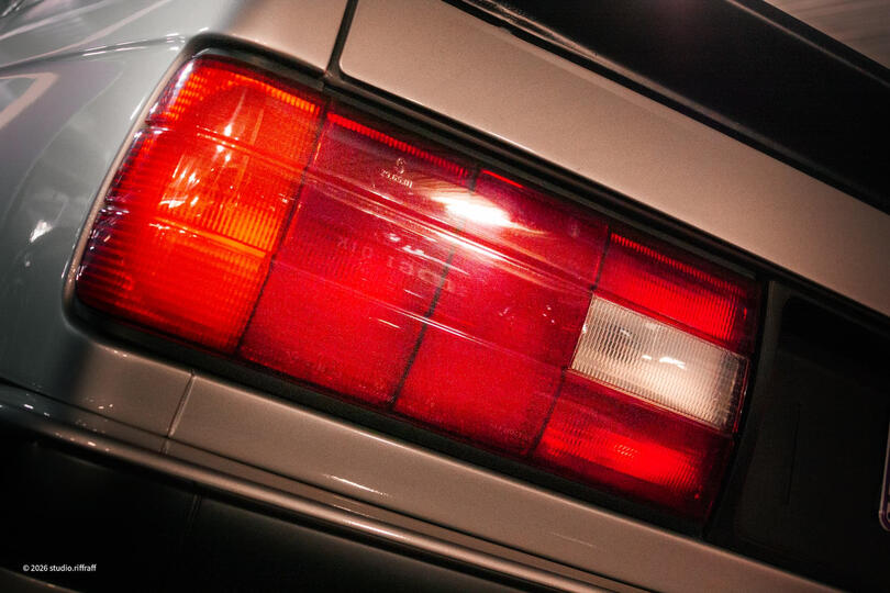 A silver BMW E30 in a parking garage, lit by the morning light A silver BMW E30 in a parking garage, lit by the morning light
